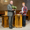 Rev Fergus Cook presents Sam with a "manly" flower arrangement