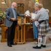 Rev Fergus Cook presents Mabel with a gift